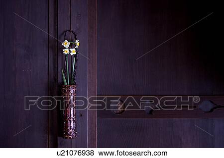Daffodils in a vase hanging in a house View Large Photo Image Stock Photo - Daffodils in a vase hanging in a house. Fotosearch