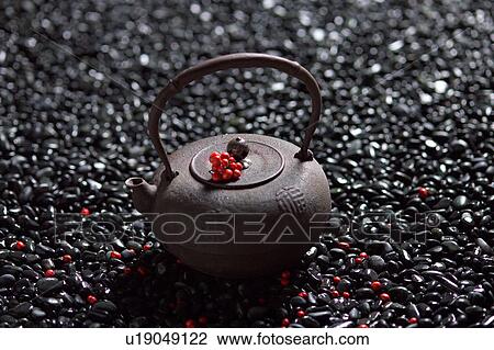 Stock Image - Nandina on tea pot. Fotosearch