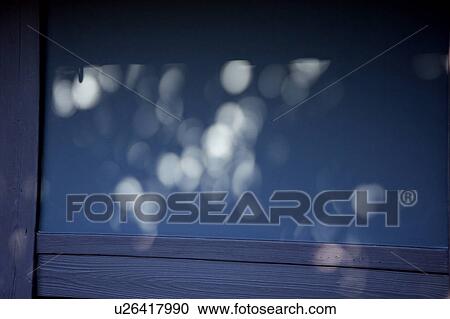 Stock Image - Sunlight reflected on a door. Fotosearch