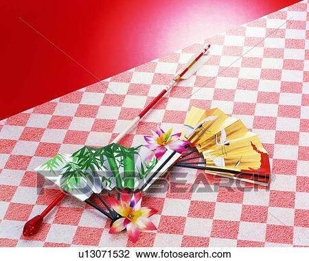 Stock Image - Folding fan and arrow. Fotosearch