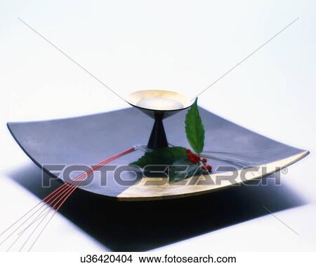 Picture - Sake cup and nandina on plate. Fotosearch