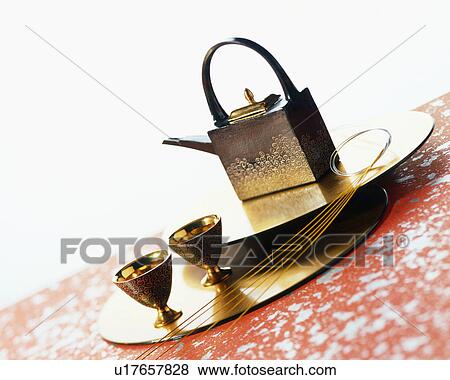 Stock Photo - Sake pot and cups on a tray. Fotosearch