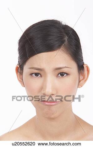 Stock Image - Portrait of Natural Young girl pulling facial expression. Fotosearch