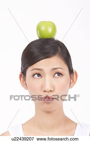 Portrait of Natural Young girl with an Apple on Her Head View Large Photo Image Stock Photo - Portrait of Natural Young girl with an Apple on Her Head. Fotosearch