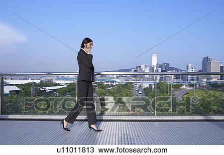 Young Businesswoman using Mobile Phone, Walking: 1; View Large Photo Image Stock Image - Young Businesswoman using Mobile Phone, Walking: 1;. Fotosearch