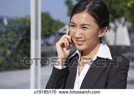 Young Businesswoman using mobile phone, Smiling View Large Photo Image Stock Image - Young Businesswoman using mobile phone, Smiling. Fotosearch