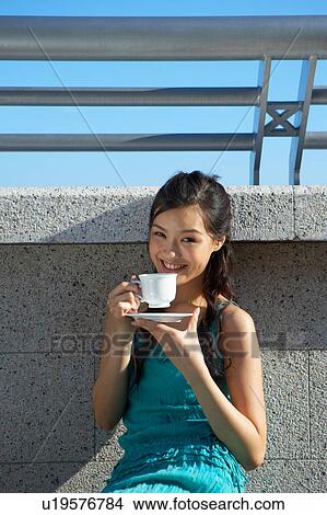Young Lady Sitting on Floor, Drinking Cup of Tea View Large Photo Image Picture - Young Lady Sitting on Floor, Drinking Cup of Tea. Fotosearch