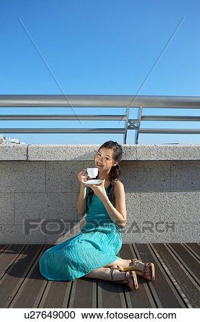 Young Lady Sitting on Floor, Drinking Cup of Tea View Large Photo Image Stock Image - Young Lady Sitting on Floor, Drinking Cup of Tea. Fotosearch