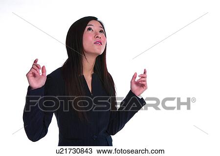 Young woman in business suit, looking up View Large Photo Image Stock Image - Young woman in business suit, looking up. Fotosearch