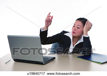 Stock Photo - Young woman in business suit, sitting, raising hand. Fotosearch
