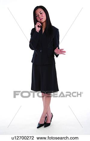 Young woman in business suit, talking over mobile phone View Large Photo Image Stock Image - Young woman in business suit, talking over mobile phone. Fotosearch