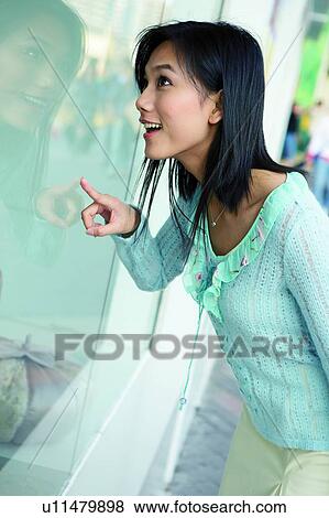 Young woman looking through the window in big surprise and happiness, close-up View Large Photo Image Stock Photo - Young woman looking through the window in big surprise and happiness, close-up. Fotosearch