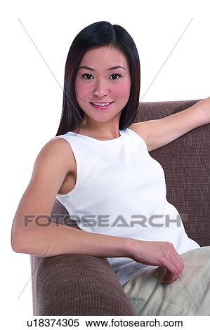 Stock Photography - Young woman relaxing on sofa. Fotosearch
