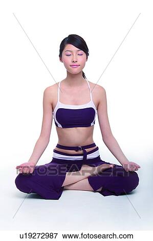 Young woman sitting cross-legged, eyes closed View Large Photo Image Stock Photo - Young woman sitting cross-legged, eyes closed. Fotosearch