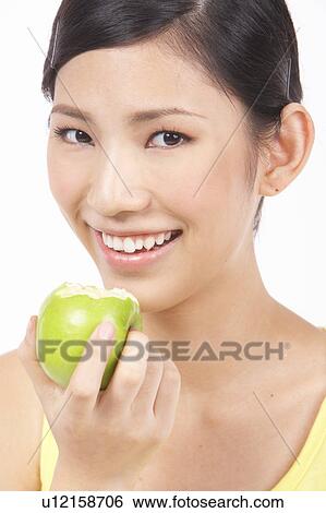 Portrait of Natural Young girl holding Apple, Smiling View Large Photo Image Stock Photograph - Portrait of Natural Young girl holding Apple, Smiling. Fotosearch