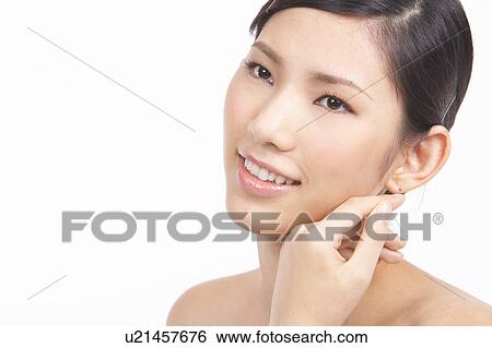 Stock Photograph - Portrait of Natural Young girl with hands next to face. Fotosearch