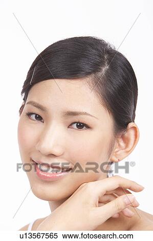 Stock Photography - Portrait of Natural Young girl with hands next to face. Fotosearch