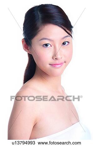 Stock Image - Young girl standing in side view. Fotosearch