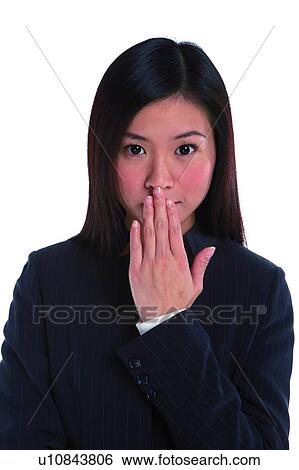 Young woman in business suit with hand on mouth View Large Photo Image Stock Photograph - Young woman in business suit with hand on mouth. Fotosearch