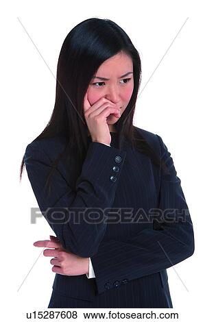 Stock Photo - Young woman in business suit with one hand on cheek and one hand on waist. Fotosearch