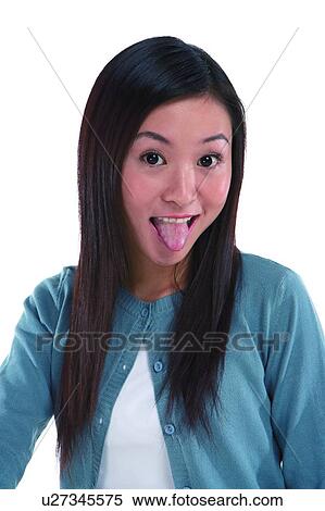 Stock Photography - Young woman looking at camera and making a face. Fotosearch