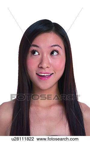 Stock Image - Young woman looking up and smile happily. Fotosearch