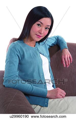 Young woman relaxing on sofa View Large Photo Image Stock Image - Young woman relaxing on sofa. Fotosearch