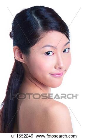 Young woman standing and turning back her head View Large Photo Image Stock Photo - Young woman standing and turning back her head. Fotosearch
