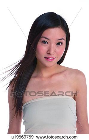 Stock Photo - Young woman standing, smiling, close-up. Fotosearch