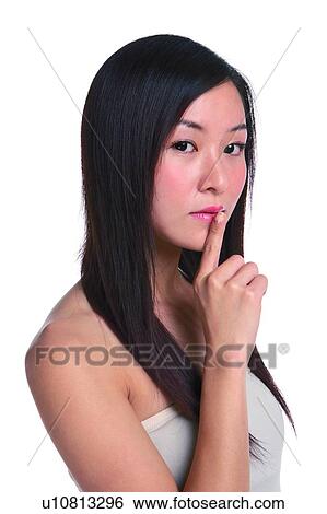 Stock Photograph - Young woman thinking with finger on lips. Fotosearch
