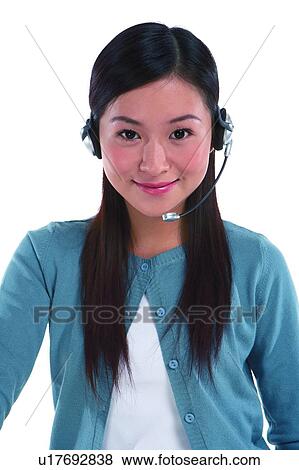 Young woman wearing headphone and smiling View Large Photo Image Stock Photo - Young woman wearing headphone and smiling. Fotosearch