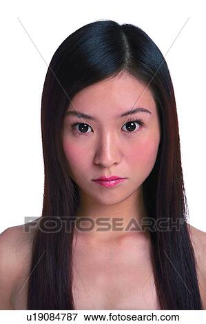 Stock Photo - Young woman with long hair looking at camera. Fotosearch