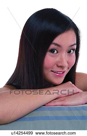 Young woman with long hair, smiling, close-up View Large Photo Image Stock Photo - Young woman with long hair, smiling, close-up. Fotosearch