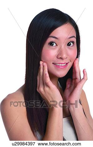 Young woman with long hair, smiling, hands cupped View Large Photo Image Stock Photo - Young woman with long hair, smiling, hands cupped. Fotosearch