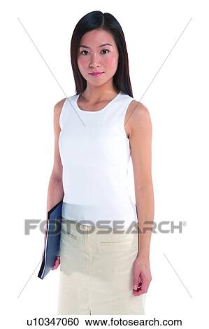 Young woman standing, holding documents, front view View Large Photo Image Stock Image - Young woman standing, holding documents, front view. Fotosearch