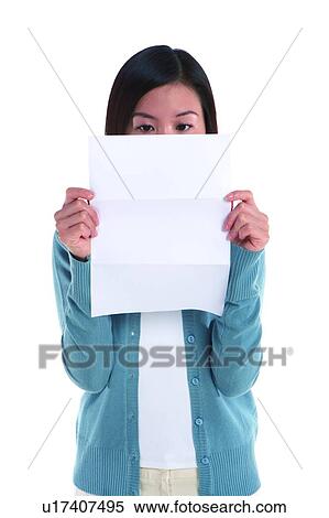 Young woman standing, reading, front view View Large Photo Image Stock Photography - Young woman standing, reading, front view. Fotosearch