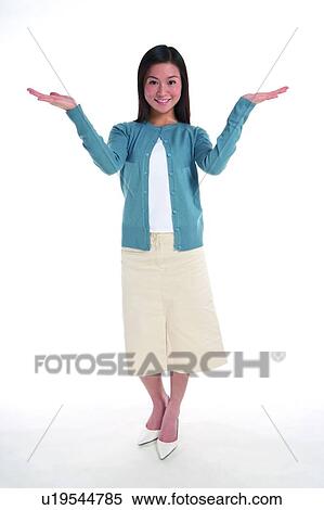Young woman standing with hands raised on two side View Large Photo Image Stock Photography - Young woman standing with hands raised on two side. Fotosearch