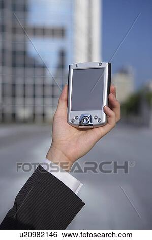 Stock Photograph - Close-Up of a Woman's Hand Holding a PDA. Fotosearch
