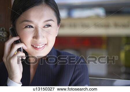 Young Businesswoman Riding Tram and using mobile phone View Large Photo Image Stock Photo - Young Businesswoman Riding Tram and using mobile phone. Fotosearch