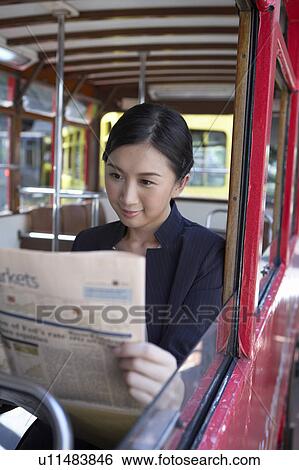 Young Businesswoman Riding Tram, Reading Newspaper View Large Photo Image Stock Photograph - Young Businesswoman Riding Tram, Reading Newspaper. Fotosearch