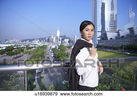Young Businesswoman Standing in Street View Large Photo Image Stock Photo - Young Businesswoman Standing in Street. Fotosearch