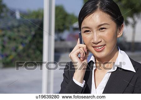 Young Businesswoman using mobile phone, Smiling View Large Photo Image Stock Image - Young Businesswoman using mobile phone, Smiling. Fotosearch