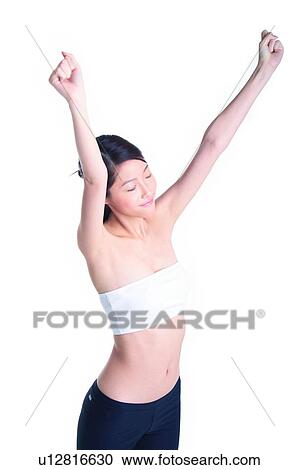 Stock Image - Young girl standing and stretching. Fotosearch