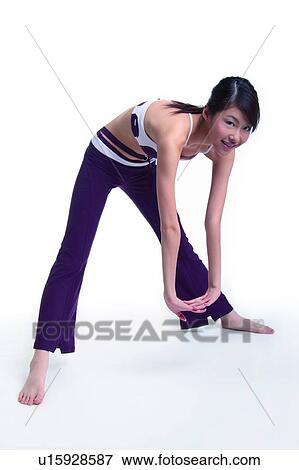 Young woman bending forward, smiling View Large Photo Image Stock Photo - Young woman bending forward, smiling. Fotosearch