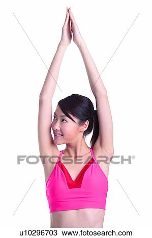 Stock Image - Young woman doing exercise, stretching. Fotosearch