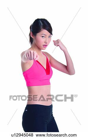 Stock Photo - Young woman in fighting stance. Fotosearch