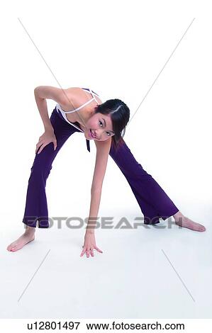 Stock Photo - Young woman in yoga position, smiling. Fotosearch