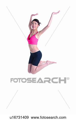 Stock Photo - Young woman jumping up. Fotosearch