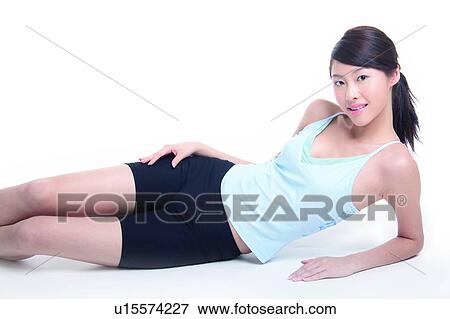 Young woman lying on floor View Large Photo Image Stock Photo - Young woman lying on floor. Fotosearch