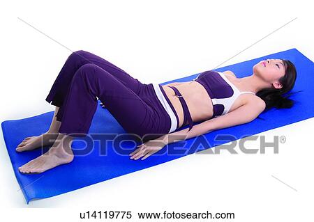 Young woman lying on mat View Large Photo Image Stock Photography - Young woman lying on mat. Fotosearch